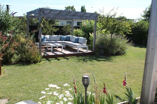 a gazebo with a couch in a yard at Marlborough Wine Country B&B in Blenheim
