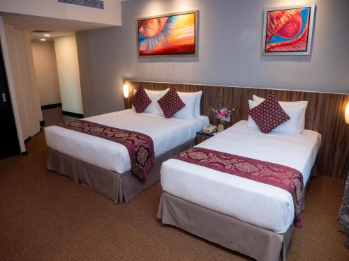 a hotel room with two beds in a room at Hotel Royal Kuala Lumpur in Kuala Lumpur