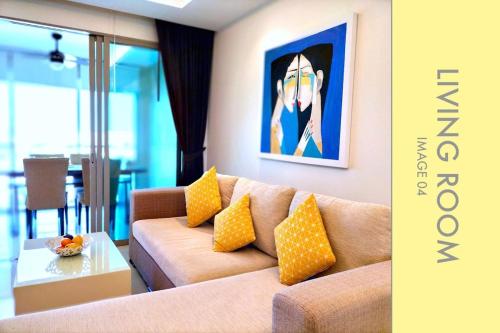 a living room with a couch and a painting on the wall at Modern 2-Bedroom Condo in Kamala Near the beach in Kamala Beach