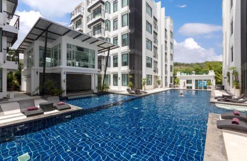 a swimming pool in the middle of a building at Modern 2-Bedroom Condo in Kamala Near the beach in Kamala Beach