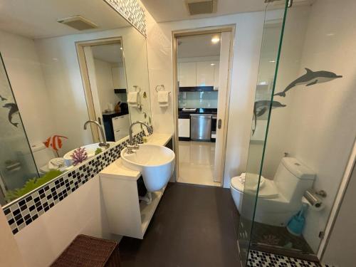 a bathroom with a sink and a toilet and a shower at Modern 2-Bedroom Condo in Kamala Near the beach in Kamala Beach