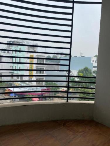 a room with a window with a view of a building at Candy Hotel Can Tho in Cái Răng