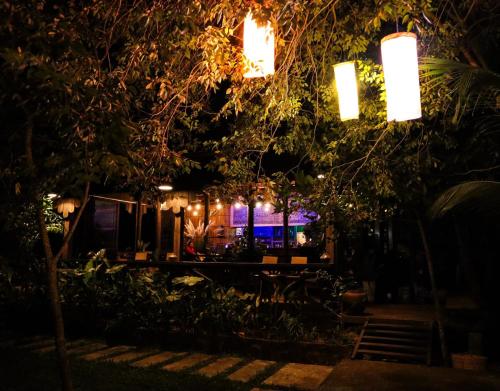 a night view of a restaurant with lights at Villa Romduol in Kampot