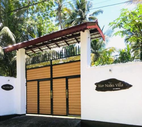 a garage door with a sign in front of it at Star Nodes Villa in Galle