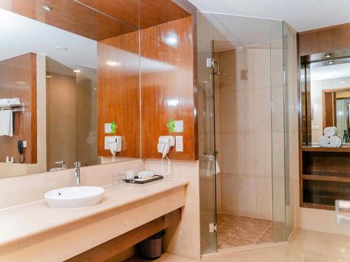 a bathroom with a sink and a shower at AURORA Hotel Plaza in Bien Hoa