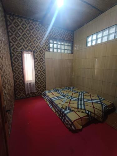 a room with a bed in the corner of a room at Villa Bidadari in Ciater