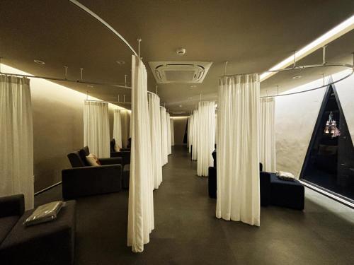 a hallway with curtains and couches in a room at 사이공 트래블 라운지 Saigon Travel Lounge in Ho Chi Minh City