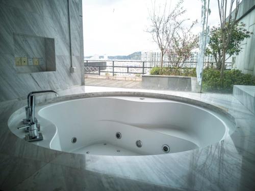 a bath tub in a bathroom with a window at Crowne Plaza Huangshan Yucheng by IHG in Huangshan