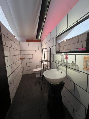 a bathroom with a sink and a toilet at Trizara Resorts - Glam Camping in Lembang