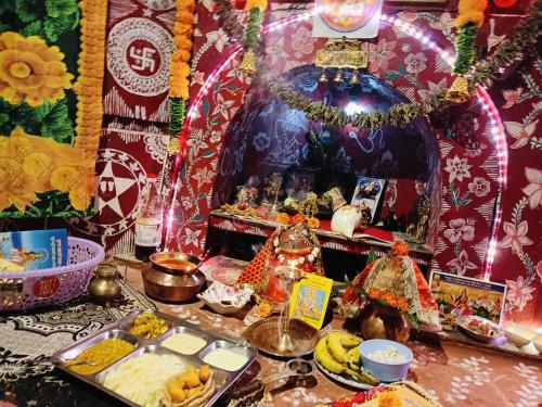 a altar with food and other items on a table at Eja Homestay Falsima in Almora