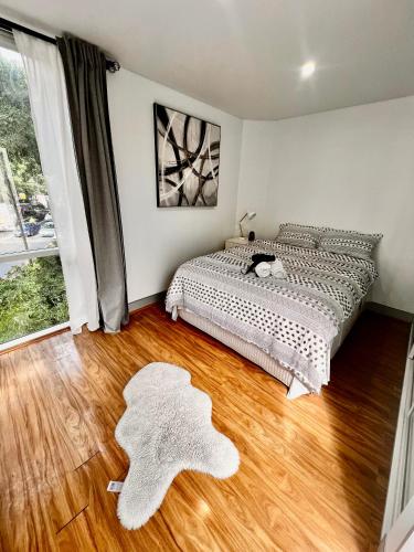 a bedroom with a bed and a wooden floor at Bondi View room-Close to the Beach in Sydney