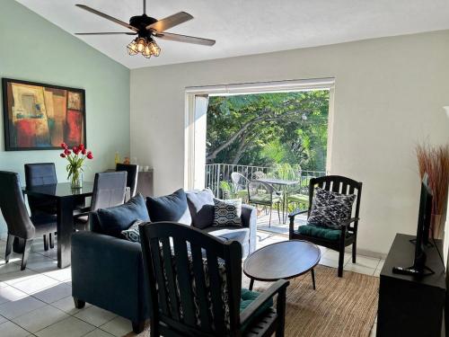 a living room with a couch and chairs and a table at 2 Bedroom Treetop Condo in Puerto Vallarta