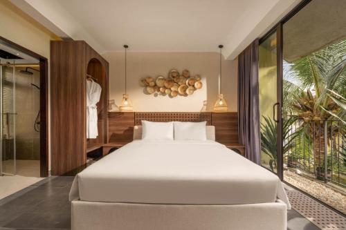 a bedroom with a large white bed and a window at Peaceful 2BDR Hoi An APT near An Bang beach and Ancient Town in An Bang