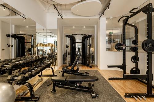 a gym with rows of exercise equipment and mirrors at The Zénith, By Harrys in Hanoi