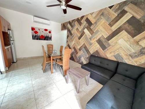 a living room with a couch and a table at Villas Paraíso in Mérida