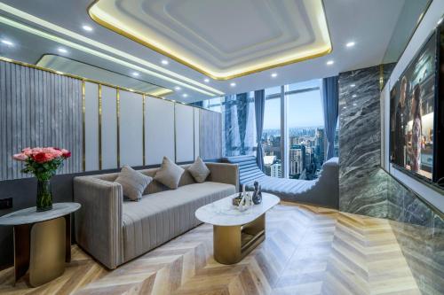 a living room with a couch and a table at Yunmulijin Sky High Riverview Hotel Chongqing Jiefangbei Raffles Plaza in Chongqing