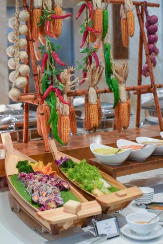 a table topped with a tray of food with vegetables at Le's Cham Hotel in Nha Trang