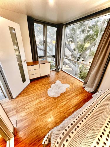 a bedroom with a bed and a large window at Bondi View room-Close to the Beach in Sydney