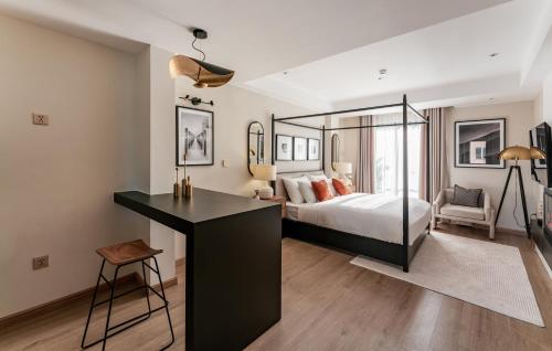 a bedroom with a bed and a desk in it at The Zénith, By Harrys in Hanoi