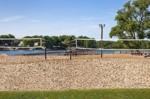 a beach with a volley ball court and a net at AmericInn by Wyndham La Crosse Riverfront-Conference Center in La Crosse