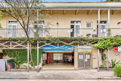 an entrance to a building with a balcony at Newtown Backpackers in Sydney