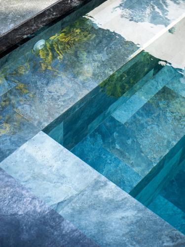 a glass window with a reflection of a street at Paraluman, large Villa with pool in El Nido