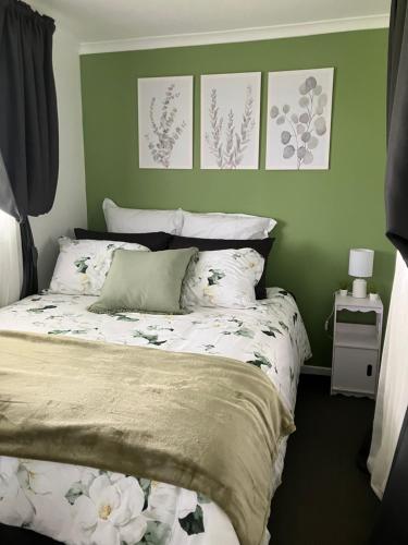 a bedroom with a bed with flowers on it at Tack Room in Borambola