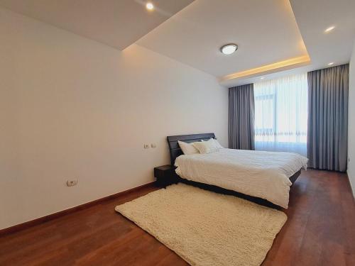 a bedroom with a bed and a rug at Exquisite Sanctuary Of Luxury Bole in Addis Ababa