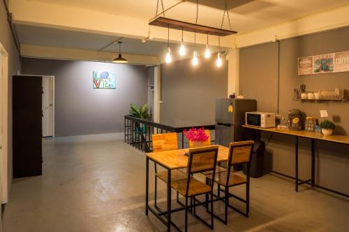 a kitchen with a table and chairs in a room at Love CNX Guesthouse in Chiang Mai