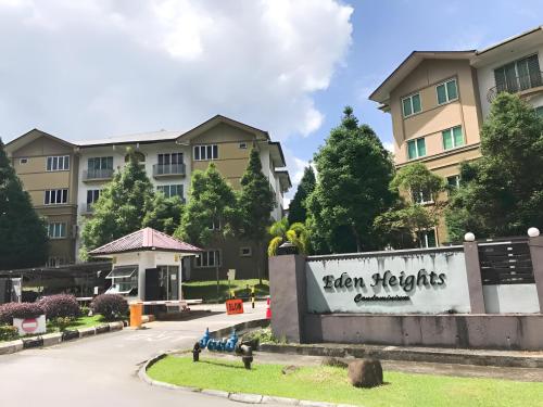 a sign in front of a building at Natol Homestay - Kuching Home Penthouse Airport Road in Kuching
