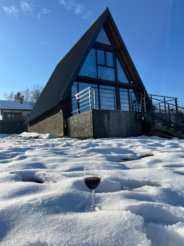 a glass of wine in the snow in front of a building at BlackPoolHouse in Belgrade