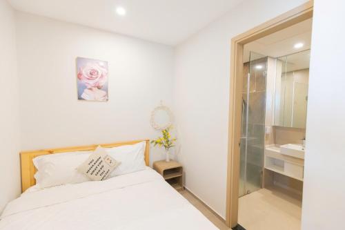 a bedroom with a bed and a glass shower at The Sóng Vũng Tàu- SAO VIỆT Căn Hộ Nghỉ Dưỡng 5 Sao in Vung Tau