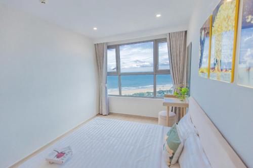 a bedroom with a bed and a large window at The Sóng Vũng Tàu- SAO VIỆT Căn Hộ Nghỉ Dưỡng 5 Sao in Vung Tau