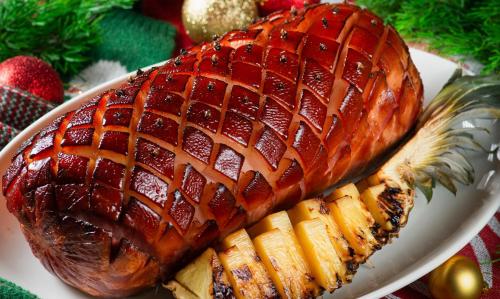 a large ham on a white plate with some fruit at Shangri-La Jinan in Jinan