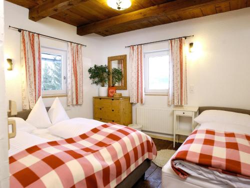 a bedroom with two beds and two windows at Farmhouse in Hollersbach near KitzSki in Hollersbach im Pinzgau