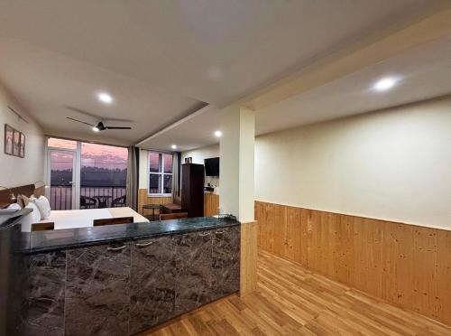 a living room with a large stone counter in a room at Himalayan Suite in Dharamshala