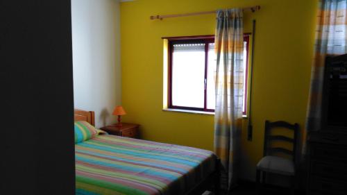 A bed or beds in a room at Pousada Farol do Portinho