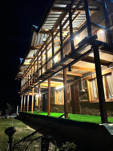 a house lit up at night with lights at Ch'i Soulstone HomeStay in Sainj