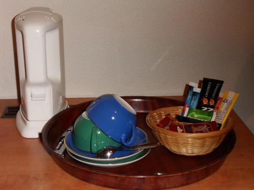 a wooden tray with a tea pot and a basket at Villa Voorncamp in Schoonhoven
