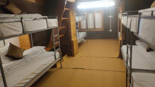 a group of bunk beds in a dorm room at Ch'i Soulstone HomeStay in Sainj
