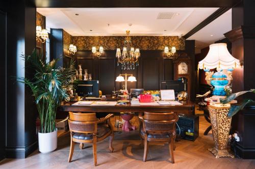a dining room with a large wooden table and chairs at Beijing Xiaofengxian Former Residence Hotel Tiananmen Square Qianmen Store in Beijing