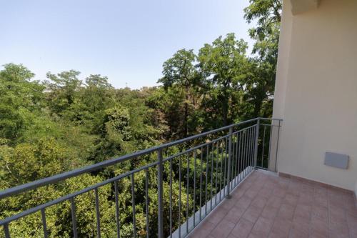 a balcony with a view of trees at Antares Rooms and Suites in Olbia