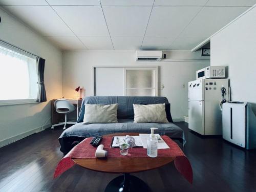 a living room with a bed and a table at Yadomachi sakura - Vacation STAY 54783v in Hakodate