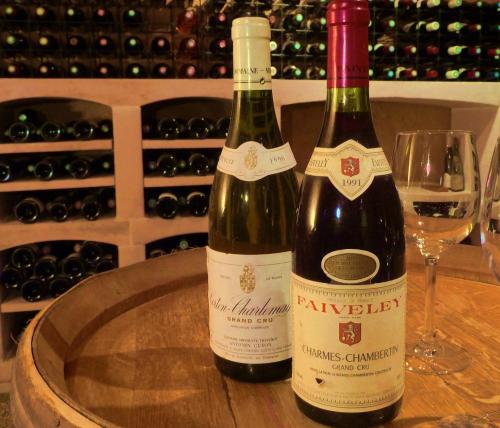 two bottles of wine sitting on top of a table at Moulin Renaudiots - Maison d'hôtes in Autun