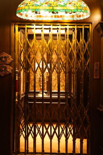 an iron gate with a stained glass window at Beijing Xiaofengxian Former Residence Hotel Tiananmen Square Qianmen Store in Beijing