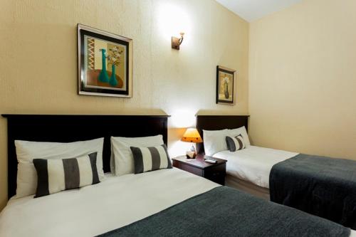 Ένα ή περισσότερα κρεβάτια σε δωμάτιο στο Mokorro Hotel