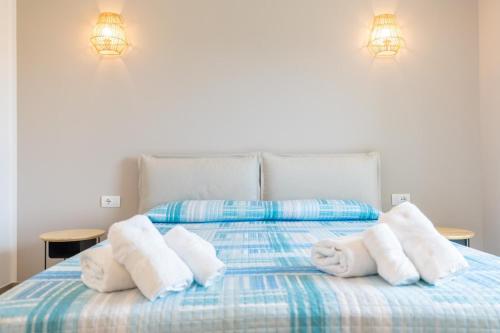 a bed with towels sitting on top of it at Antares Rooms and Suites in Olbia