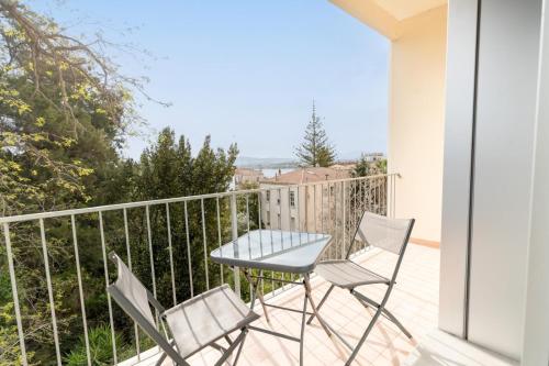 a balcony with two chairs and a table on a balcony at Antares Rooms and Suites in Olbia