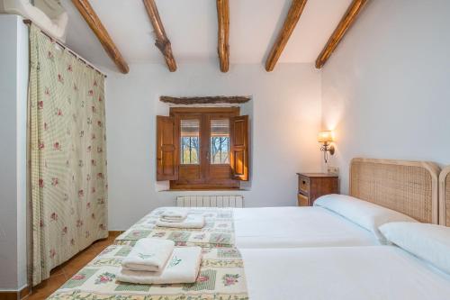 Postel nebo postele na pokoji v ubytování Casa Rural La Roca