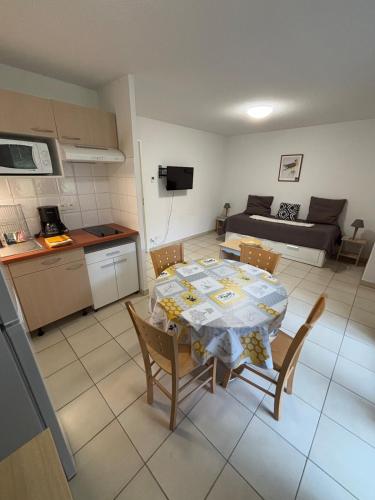 une cuisine et une salle à manger avec une table et des chaises dans l'établissement Balcons de la Neste Arreau C, à Arreau